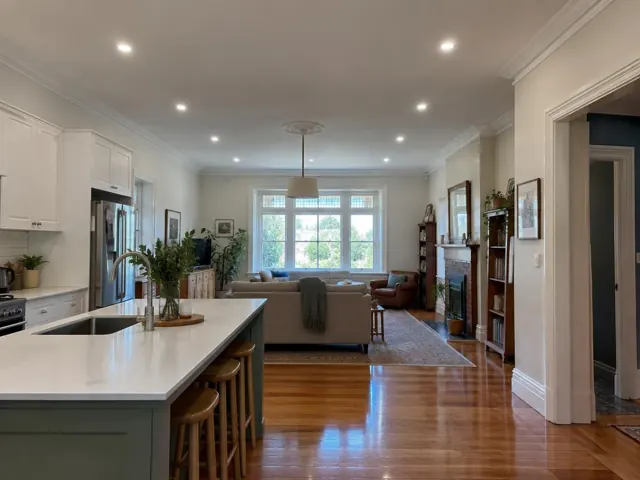 Open-plan kitchen and living room with recessed LED downlights in a plaster ceiling in Teralba